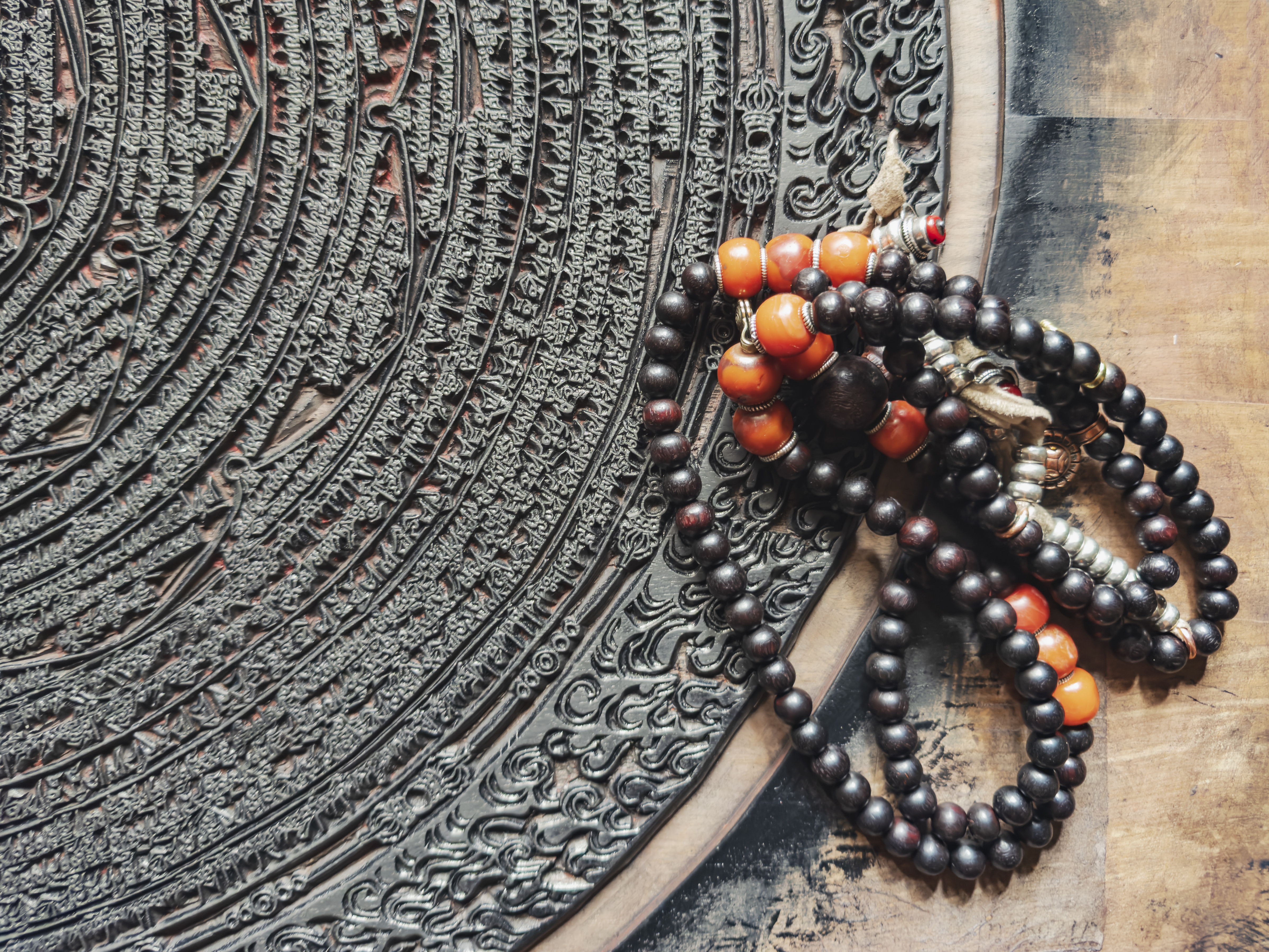 Prayer beads on intricate religious carving